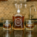 Whiskey decanter with two glasses on a bar counter